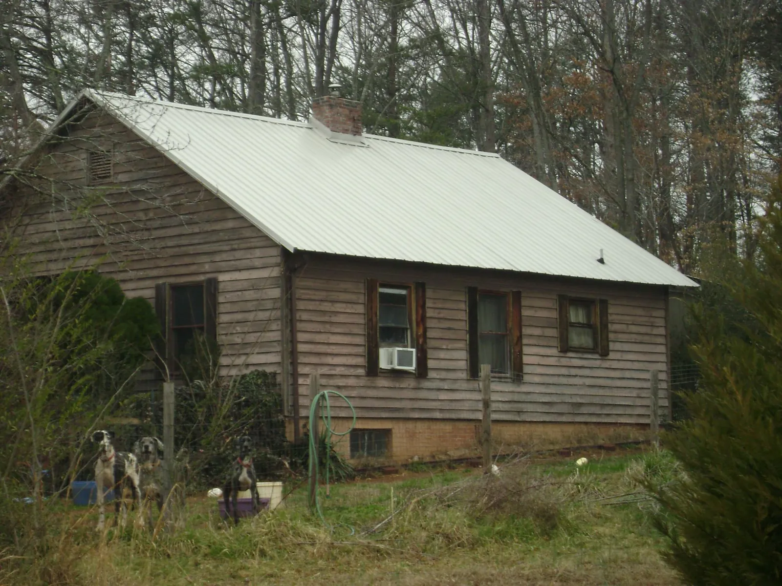 White metal roof on an old wood sided farmhouse, from a Metal Roof Installation job in Ransom